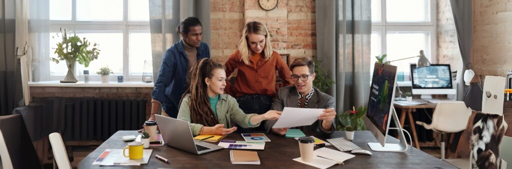 5 Estratégias Avançadas para Integrar Marketing Digital e Anúncios Impressos 8 Profissionais analisando estratégias de marketing digital integradas com ações impressas.